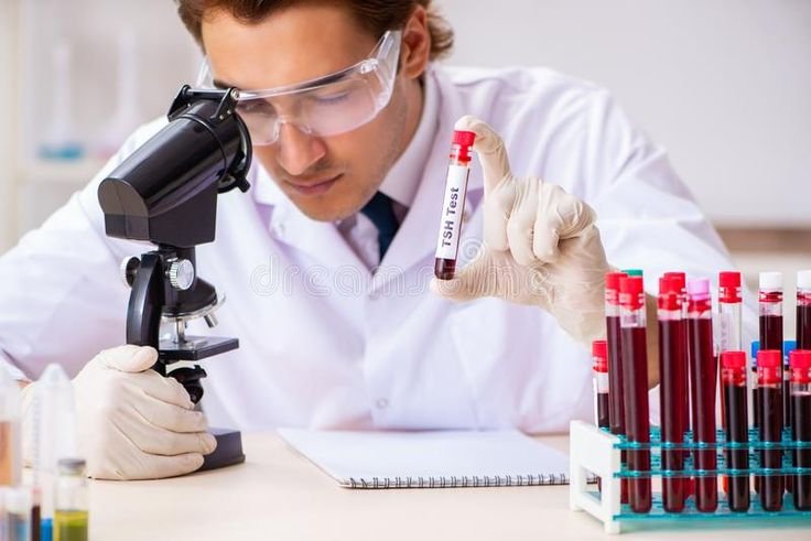 the young handsome lab assistant testing blood samples in hospital stock photo image of infection, medical 134248060